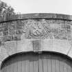 View of old dormer head heraldic panel over corner archway, St Mary's Church burial ground, Banff.