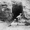 Excavation photograph: destryed east wall of Great Tower, showing overlying earthen bank.