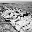 Excavation photograph : Late paving upper fort entrance facing NE wall showing beyond.