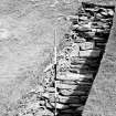 Excavation photograph : Trench against NW wall of broch with low platform.