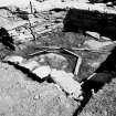 Excavation photograph : hearth with later walling over in cell in fort wall.