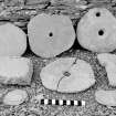 Excavation photograph : rotary quern stones and discs.