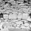 Excavation photograph : slab lined depression below primary floor of broch.