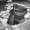 Excavation photograph : west side of well showing three rock cut steps.