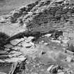 Excavation photograph : primary floor of broch and flagging concealing well.