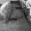 Trench 1,area A,feature 3 after cleaning, showing relationship of upright slab,N wallface,possible end packing stone,cobble layer and pot in section 2, from East.