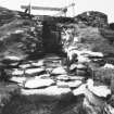 Excavation photograph -  Entrance passage, after clearing, looking towards broch entrance through "forework", from E-NE.
Photographic copy of polaroid print. Copied 1995.
