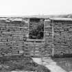 Survey photograph : site 35b - agricultural/storage unit, with small sub-structure at east end.  Drystone construction, partially surviving turf roof.