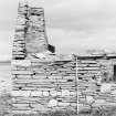 Survey photograph : site 51b - end of front elevation of earlier domestic unit, with internal access to byre; and living area with chimney at either end.