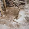 Excavation photograph.  Cell 4 Pit 1 with bone (burnt).
