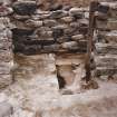 Excavation photograph.  Showing stack of pot lids.
