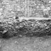 Excavation photograph : section through upper levels of debris (f101 and 102) of North Tower, from N.