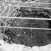 Excavation photograph : post occupation debris (f103) in situ, from E.