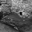 Excavation photograph : recess within wall of tower, showing drain outlet, from S.