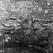 Excavation photograph : blocked doorway and window recess on S side of tower, from N.