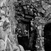 Excavation photograph : N tower - base of stair within thickness of west wall that led upwards from first floor level, from S.