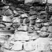 Excavation photograph : detail of masonry at back of fireplace, from S.