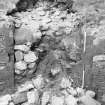 Excavation photograph : rubble collapsing from infill if window recess in SE of N tower, from NW.