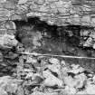 Excavation photograph : partially collapsed S wall with gatehouse behind, from N.