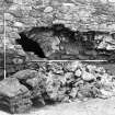 Excavation photograph : S wall after further collapse showing part of arch supporting stair to first floor of E range and gatehouse, from N.