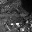 Excavation photograph : 'Bomb' in trench 006 924. Iron pipe? ; from north-west.