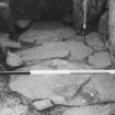 Excavation photograph - view of paving in square 5 looking W