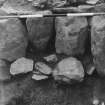 Excavation photograph - west wall section of outer chamber - stone packing under the "mill wheel" (removed)