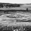 Excavation photograph : cairn, all infilling removed - ring and central cairn remaining, from north.