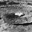 Excavation photograph : cist slab with pyre packed up against it.