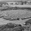 Excavation photograph : cairn cleaned to cobbled surface, from north-west.