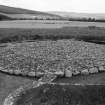 Excavation photograph : cairn cleaned to cobbled surface, from south-west.