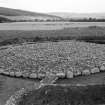 Excavation photograph : cairn cleaned to cobbled surface, from south-west.