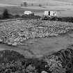 Excavation photograph : cairn in quadrants NE/SW to structure level, NW/SE to cobble surface, from north-east.