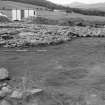 Excavation photograph : cairn, stone filling - 2 quadrants off, from north-east, at ground level.