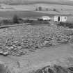 Excavation photograph : cairn cleaned to cobbled surface from north-east.