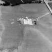 Oblique aerial view of linear cropmarks under excavation.