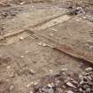 Excavation photograph : area 2 - f2002, Hut G, with late floor exposed in foreground, from NW.