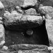 Excavation photograph showing cist with food vessel and knife.