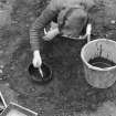 Staved wooden bowl being excavated.