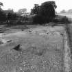Excavation photograph : ditch and house from south-east.