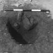 Excavation photograph : F8029 - post hole, half sectioned, from SE.