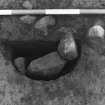 Excavation photograph : area 5 - F037 - half section of stone packed post hole from NE.