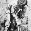Excavation photograph : F T Wainwright picking with farm grieve.