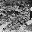 Excavation photograph : central paving and Isobel Gibb in narrow passage.