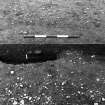 Excavation photograph : trench 1 - features ACL and ABV, pits within ring-ditch AAT, House 3 (House 2 in publication), half sectioned.