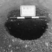 Excavation photograph : trench II - fBAK, posthole half sectioned, facing north-west.