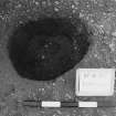 Excavation photograph : trench II - posthole BBH, excavated, facing west.