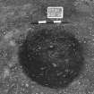 Excavation photograph : trench II - posthole BDG, from above, facing south-west.