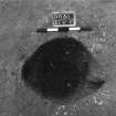 Excavation photograph : trench II - posthole BEW, excavated, from above, facing east.