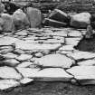 Excavation photograph : paving in hut 1.